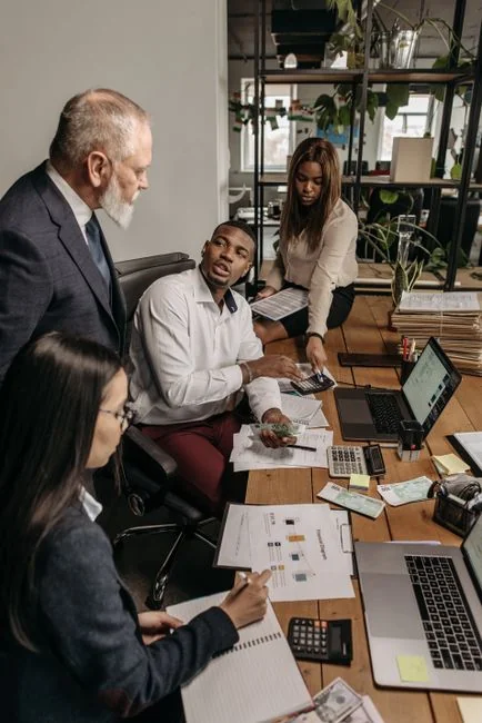 Business professionals collaborating on financial data analysis in a modern office setting.